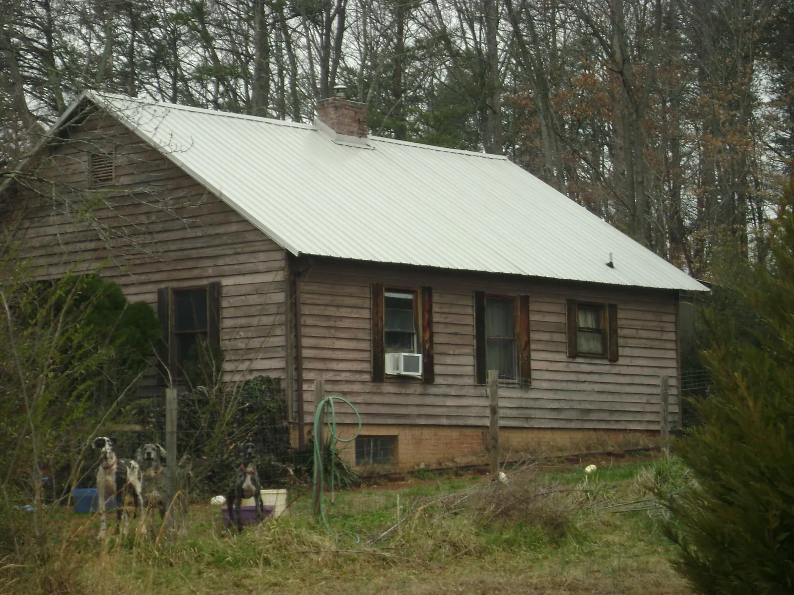 White metal roof on an old wood sided farmhouse, from a Metal Roof Installation job in Norlina